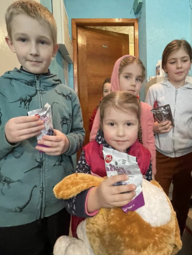 kids in Ukraine receiving food and sweets